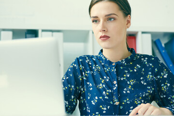 Beautiful young businesswoman working  on a laptop in the office. Business, exchange market, job offer, analytics research, excellent education, certified public accountant concept