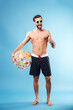 © Drobot Dean - Full length portrait of a happy guy holding beach ball