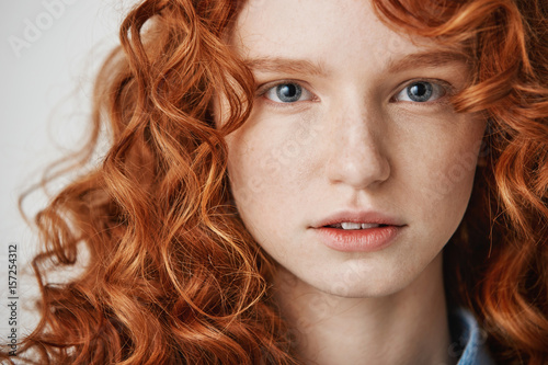 Close Up Of Beautiful Natural Ginger Girl With Freckles Looking At