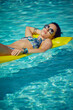 © ZoomTeam - A woman in the pool floats on a blown mattress