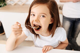 Fototapeta Do pokoju - Pretty little girl eating a chocolate cake