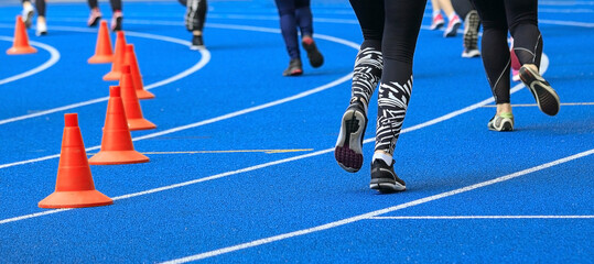 Treadmill at the stadium and athletes.