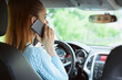 © spaxiax - woman using smartphone while driving a car