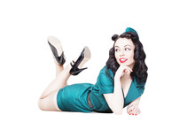 Portrait Of Cute Sexy Brunette With Black Hair. Pin Up Female Dressed In Military Clothing Uniform And Garrison Cap With Legs In The Air. Army Pin-up Girl Concept