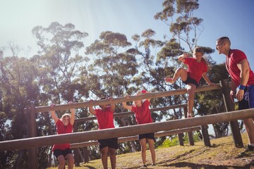 Wall Mural - trainer instructing kids during obstacle course training