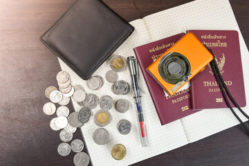 Two Thailand passports with digital camera coin money and book t