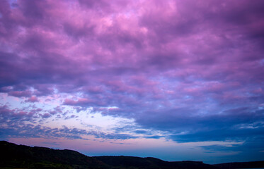 Photo of a violet sunset with clouds