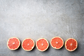 Wall Mural - Red grapefruits on stone background