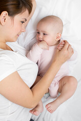 Fototapete - mother playing with her baby infant