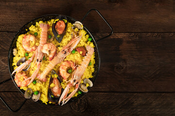 Wall Mural - Spanish seafood paella in paellera with copyspace