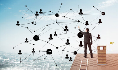businessman on house roof presenting networking and connection concept. mixed media