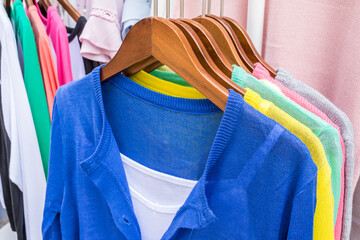 Colorful women's clothes hanging on a rack