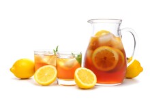 Pitcher Of Iced Tea With Two Glasses And Lemons Isolated On A White Background