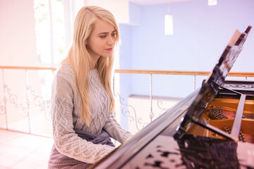 Wall Mural - Beautiful girl playing piano