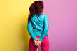 beautiful young woman with purple hair wearing blue leather jacket and magenta jeans. standing pose, isolated on colored background.