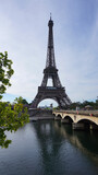 Fototapeta Most - Photo of Eiffel Tower on a spring cloudy morning, Paris, France