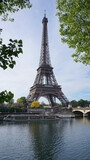 Fototapeta Boho - Photo of Eiffel Tower on a spring cloudy morning, Paris, France