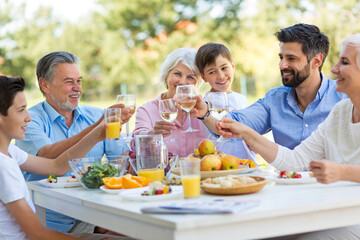 Extended family eating outdoors
