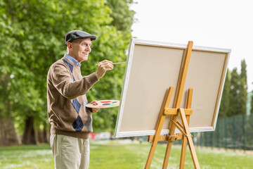 Poster - Elderly man painting on a canvas