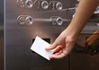 elevator access control, Hand holding a key card to unlock elevator floor befor up or down.
