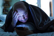 An elderly man tries to fall asleep and checks the mail or calls on the phone. Addiction on the Internet, a problem with sleep