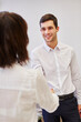 © Robert Kneschke - Young businessman shaking hands with businesswoman