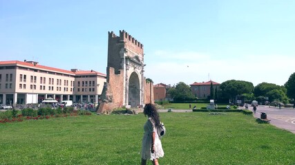 Poster - tourist near Arch in Rimini, Italy