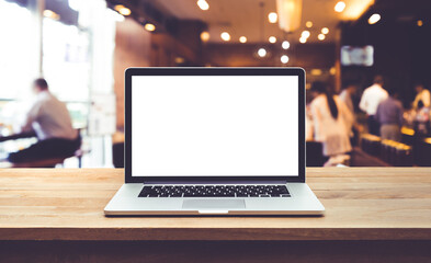 Wall Mural - Modern computer,laptop with blank screen on table with blur cafe,restaurant backgrounds.
