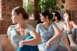 © Syda Productions - group of people doing yoga exercises at studio