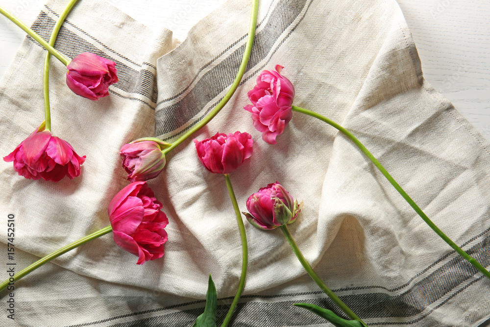 Beautiful tulip flowers on fabric background
