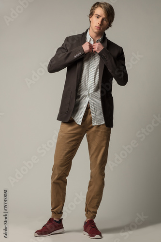 Fotografie, Obraz Chic man in white skirt and brown jacket and trousers.