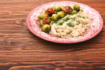 Wall Mural - Tasty chicken meat under creamy sauce with brussels sprouts garn