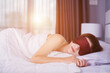 © geargodz - Woman sleeping on bed with eye mask in bedroom with soft light