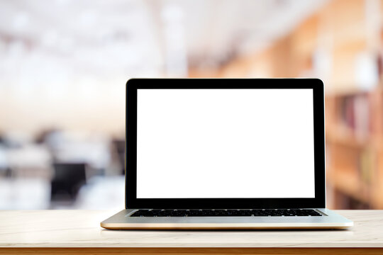  Empty screen laptop  on top marble and wooden table at blured office background. For graphic or product display montage.