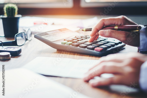 Fotografía Businessman's hands with calculator and cost at the office and Financial data an