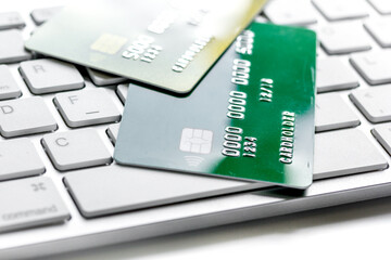 business with credit cards on keyboard office desk white background close up