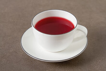 Original Red Tea Hibiscus In A White Karemic Cup. Net Food, Weight Loss, The Concept Of Vegetarian Food. Copy Space.