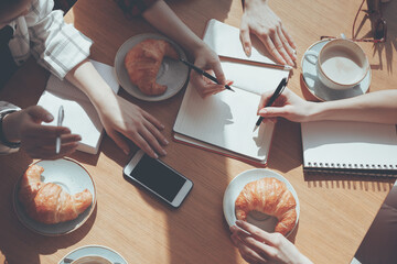 cropped view of people having lunch at meeting in cafe, business lunch concept