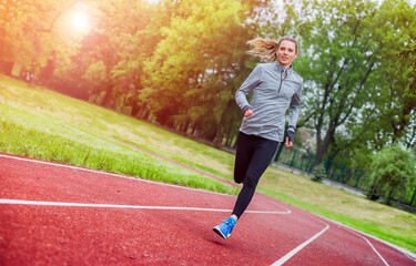 Canvas Print - Athletic woman running on track, healthy lifestyle