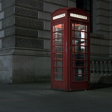 Old Red Telephone Booth At Night In London