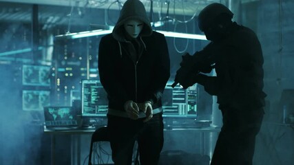 Aufkleber - Masked Hacker Wearing Handcuffs is Guarded by Fully Armed Special Forces Soldier.  They're in Hacker's Hideout Basement with Multiple Operating Displays. Shot on RED EPIC-W 8K Helium Cinema Camera.