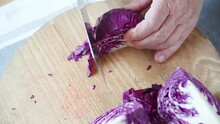 Overhead View Of A Man Slicing Cabbage For Coleslaw