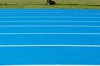 © RobbinLee - Blue Running track .Lanes of blue running track.Running track with blue asphalt and white markings in outdoor stadium.selective focus.