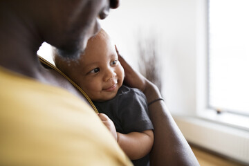 Young afro-american father with his little daughter at home.