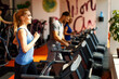 © djile - Young woman warming up on treadmill at gym
