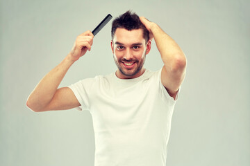 Poster - happy man brushing hair with comb over gray