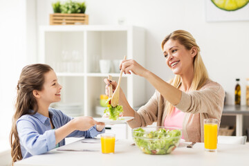 happy family eating salad at home kitchen