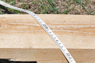 measuring bars with help of yardstick closeup.