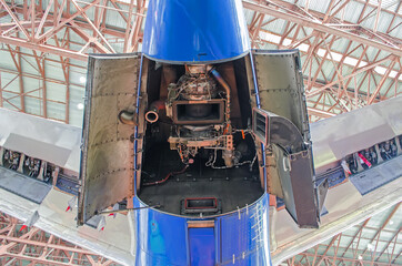 Auxiliary power plant in the tail of the aircraft with open hood covers.