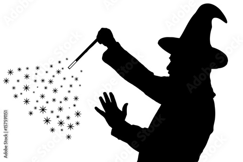 Fotomural Silhouette of bearded wizard in cloak with pointed hat creating magic